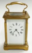Brass carriage clock with Roman enamelled dial and decorative pillars to corners of case, H11cm