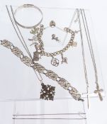A silver charm bracelet, filigree bracelet, silver bangle, silver chains and pendants, enamel