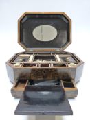 A 19thC Chinese sewing / needlework octagonal lacquer workbox with fitted interior and carved