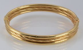 A 9ct gold three band bangle, 8.7g