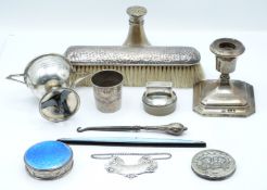 A collection of hallmarked silver items including a candlestick, Birmingham 1927, 1955 silver