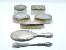 Art Nouveau hallmarked silver hand mirror, three silver backed brushes, silver handled shoe horn and