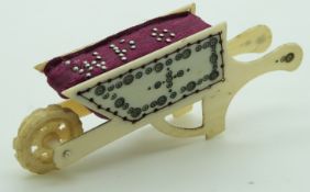 A 19thC Indian Madras ware ivory wheelbarrow pin cushion, length 8.5cm