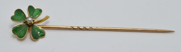 Victorian yellow metal stick pin set with green enamel and a seed pearl in the form of a four leaf