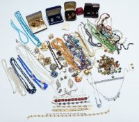 A large collection of costume jewellery including beaded necklaces, brooches, bracelets, vintage
