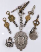 Five pocket watch keys, one Bakers Gloucester, a silver fob, and a silver brooch