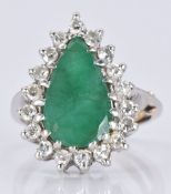 An 18ct white gold ring set with a pear cut emerald surrounded by diamonds, 5.7g, size L