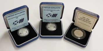 Two Royal Mint 1986 £2 silver proof coins, together with a 1992-93 silver proof 50p, all cased