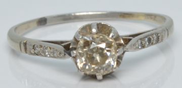 An 18ct white gold ring set with an old cut diamond of approximately 0.3ct and further diamonds to