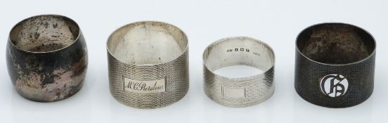 Four various hallmarked silver napkin rings, three having plain engine turned decoration, weight
