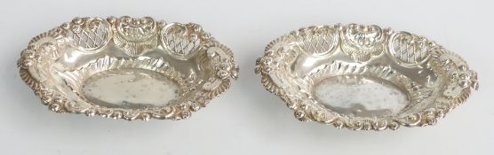 Victorian pair of hallmarked silver bon bon dishes with embossed and pierced decoration, Chester