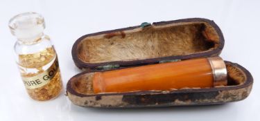 A small pot marked pure gold and an amber cheroot holder with 9ct gold mount, Birmingham 1907