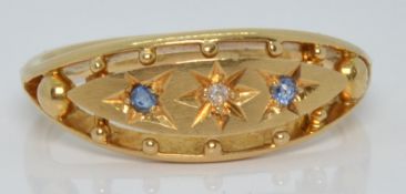 An 18ct gold ring set with a diamond and sapphires, Birmingham 1918, 4.0g, size P