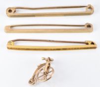 Three 9ct gold bar brooches/ tie pins and a 9ct gold charm in the form of a penny farthing, (5.8g)