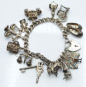 A silver charm bracelet with 12 silver charms including horses, monkey, car etc, 53g