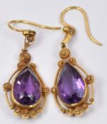 A pair of Victorian earrings set with a pear cut amethyst and filigree decoration to each, in