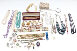 A collection of costume jewellery including brooches, silver bangle, beads etc