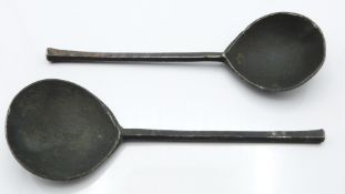 A near pair of 17th/18thC pewter spoons with touchmarks, one DG the other possibly the same but