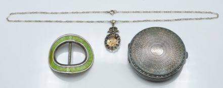 A silver compact, a silver buckle set with enamel, Birmingham 1909 and a silver necklace set with