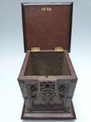 Victorian oak tea caddy or similar, with carved floral and Gothic decoration, raised on bun feet, 25