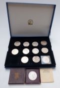 A coin tray containing twelve various modern crowns including £5 examples, a 1935 rocking horse