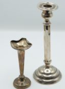 Sterling silver candlestick, height 21cm, and a hallmarked silver vase, Chester 1911, weight of both