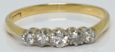 An 18ct gold ring set with five diamonds, 1.7g, size L