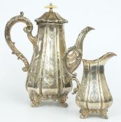 Victorian hallmarked silver ornate coffee pot and milk jug of lobed form, raised on four scroll