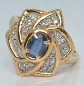 A 14k gold ring set with an oval cut sapphire and diamonds, 4.6g, size P