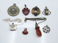 A collection of silver pendants including perfume bottle, agate, macasite, etc