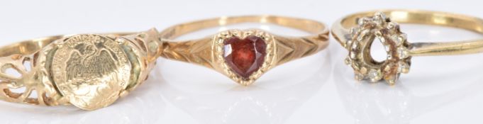 Three 9ct gold rings, one set with a heart cut garnet, 4.1g, size K, P and F