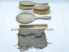 Hallmarked silver dressing table set comprising hand mirror, two brushes and comb, London 1919,