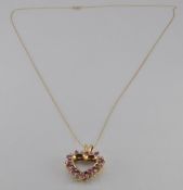 A 9ct gold heart pedant set with alternating rubies and diamonds on a 9ct gold chain, 3g