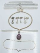 A collection of silver chains and pendants including St Christopher, ruby pendant etc, 46g