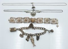 A silver charm bracelet, white metal filigree bracelet, silver and marcasite necklace and a silver