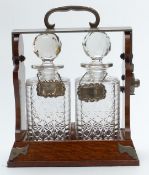 Betjemann's patent oak two-bottle tantalus, with Bramah or similar lock, height 32cm