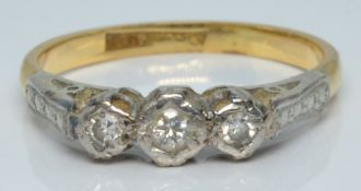 An 18ct gold ring set with three diamonds in a platinum setting, 2.6g, size L