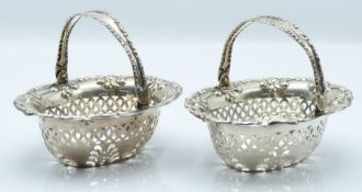 Pair of Edward VII hallmarked silver bon bon baskets with swing handles and pierced and embossed