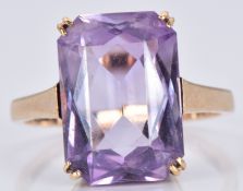 A 9ct gold ring set with a mixed emerald cut amethyst, 3.6g, size L