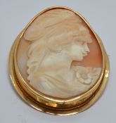An 18ct gold brooch set with a cameo depicting a young woman, 6.4 x 5cm