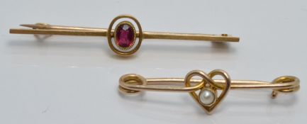 A 15ct gold brooch set with a ruby (2.4g) and a 9ct gold brooch set with a seed pearl in a heart
