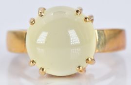 A 9ct gold ring set with an aragonite cabochon, 6.7g, size N