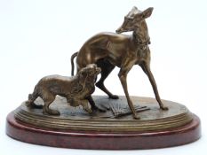 Cast bronze or similar pair of dogs with fan on the floor below, marked P.J. Mene to base, on a