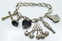 Victorian silver charm bracelet with Victorian charms including heart locket, cross pendant etc