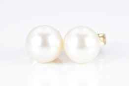 A pair of 9ct gold earrings set with a pearl to each