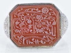 A 19thC white metal intaglio ring set with agate engraved with Arabic script, 9.9g, size L/M