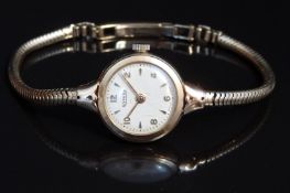 Rotary 9ct gold ladies wristwatch with gold hand, Arabic numerals and hour markers, cream dial and
