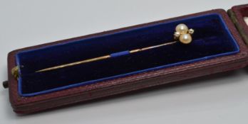 Victorian stick pin set with two split pearls and two diamonds, in original box