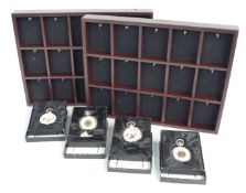 Four modern Heritage Collection pocket watches and two display racks