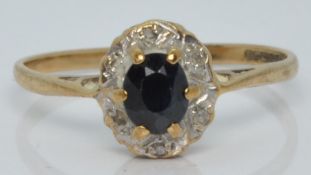 A 9ct gold ring set with a sapphire and diamonds, 1.3g, size L